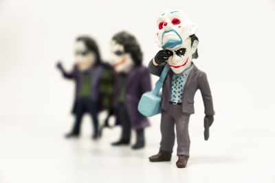 Boy standing with toy against white background