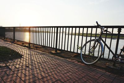 Bicycle on footpath against sky