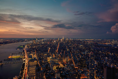 High angle view of illuminated city buildings against sky