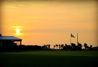 Scenic view of sunset over field