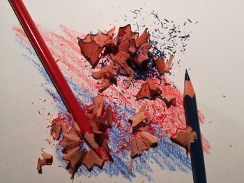 High angle view of pencil and shavings on table