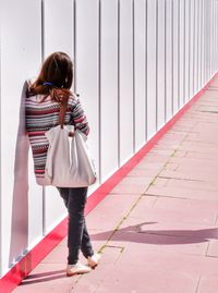 Full length of young woman standing outdoors