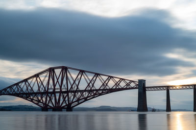 View of bridge over sea against cloudy sky