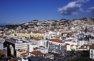 High angle view of cityscape against cloudy sky