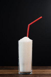 Close-up of drink on table against black background