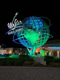 Low angle view of illuminated ferris wheel at night