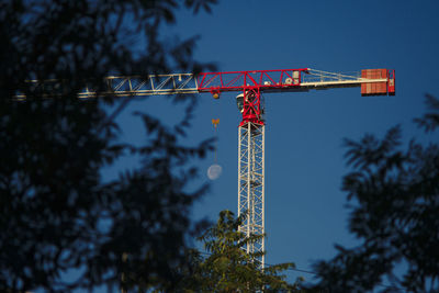 Low angle view of crane against sky at dusk
