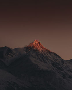 Scenic view of snowcapped mountains against clear sky