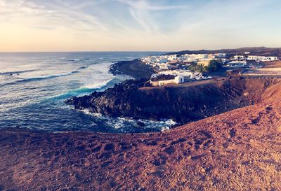 Aerial view of sea against sky during sunset