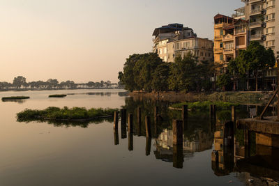 Reflection of building in lake against clear sky