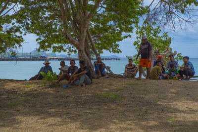 Group of people relaxing on shore