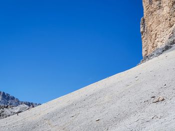 Low angle view of mountain against clear blue sky