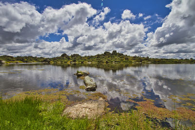 View of lake against cloudy sky