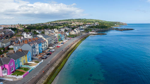 High angle view of sea and buildings against sky