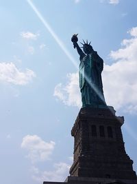 Low angle view of statue against cloudy sky