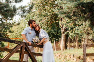 Newlywed couple embracing outdoors