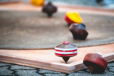 Close-up of spinning tops on table