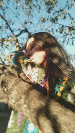 Low angle view of young woman looking away