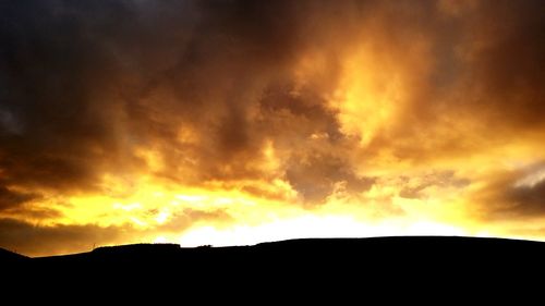 Scenic view of dramatic sky during sunset