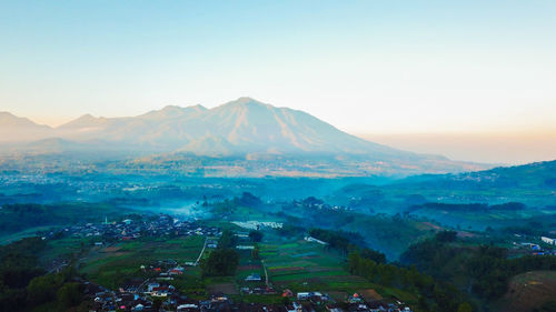 High angle view of townscape and mountains against sky