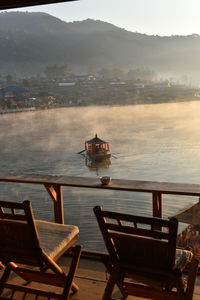 Chairs and tables at restaurant against sky