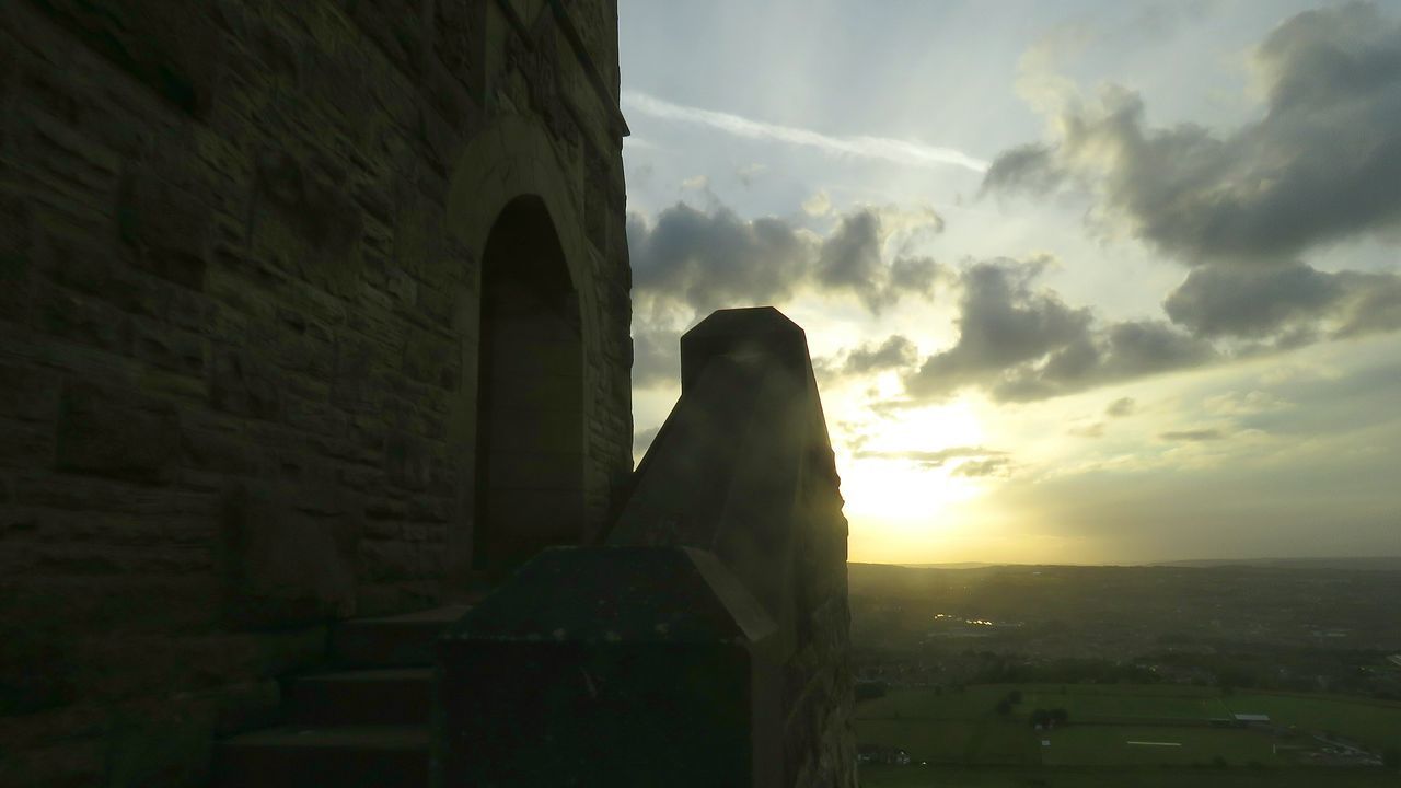 LOW ANGLE VIEW OF BUILDING AT SUNSET