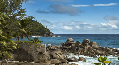 Bright landscape. lagoon with turquoise water, waves beating on the rocky coast, seychelles.