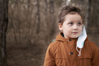 Portrait of boy standing outdoors