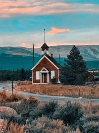 Chapel on field against sky