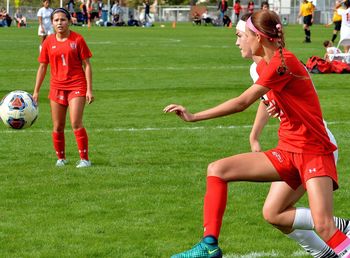 Woman playing soccer on field