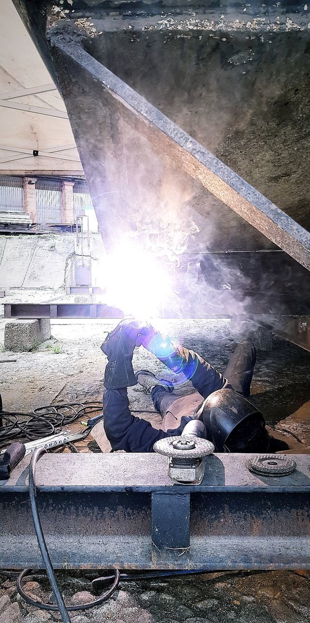 real people, working, occupation, men, welding, smoke - physical structure, people, day, architecture, protective workwear, heat - temperature, industry, welder, protection, full length, built structure, sparks, metal, metal industry