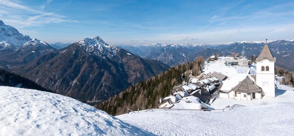 Scenic view of snow covered mountains against sky