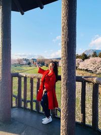 Portrait of woman standing against sky