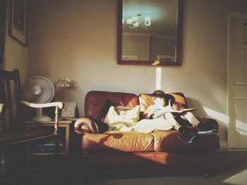 Man sleeping on sofa at home