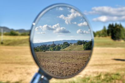 Scenic view of field seen through glass