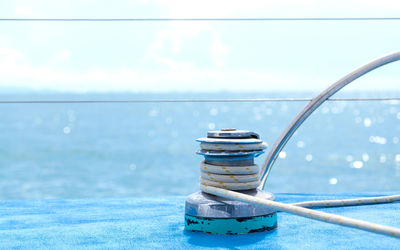 Rope tied to boat on sea against sky