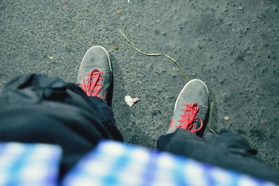 Low section of man standing on footpath