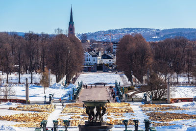 Buildings in city against clear sky during winter