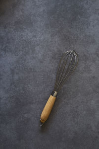 High angle view of wire whisk on table