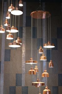 Low angle view of illuminated pendant lights hanging on ceiling