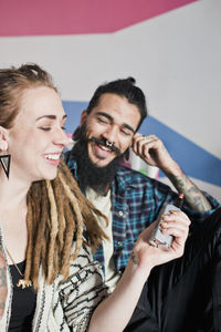 Young couple using an electronic cigarette