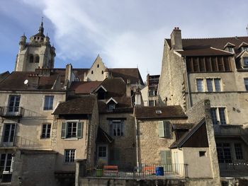 Low angle view of buildings in town against sky