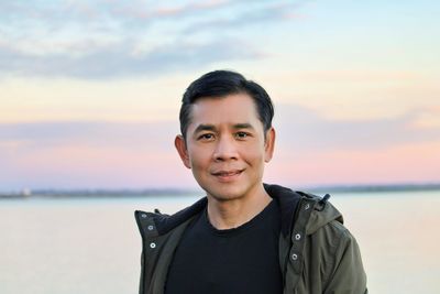 Portrait of young man standing at beach