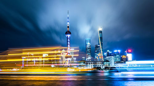 Illuminated buildings against sky at night