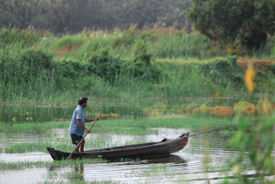 Man rowing boat on lake