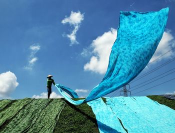 Low angle view of rope on field against sky