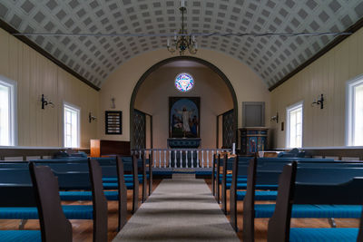 Empty chairs and tables in building