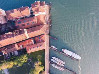 High angle view of boats at harbor by built structure