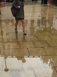 Low section of woman walking on floor