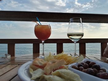 Close-up of fruits on table against sea